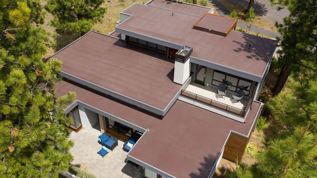 Flat roof on a modern home with a level surface and minimal slope. 
