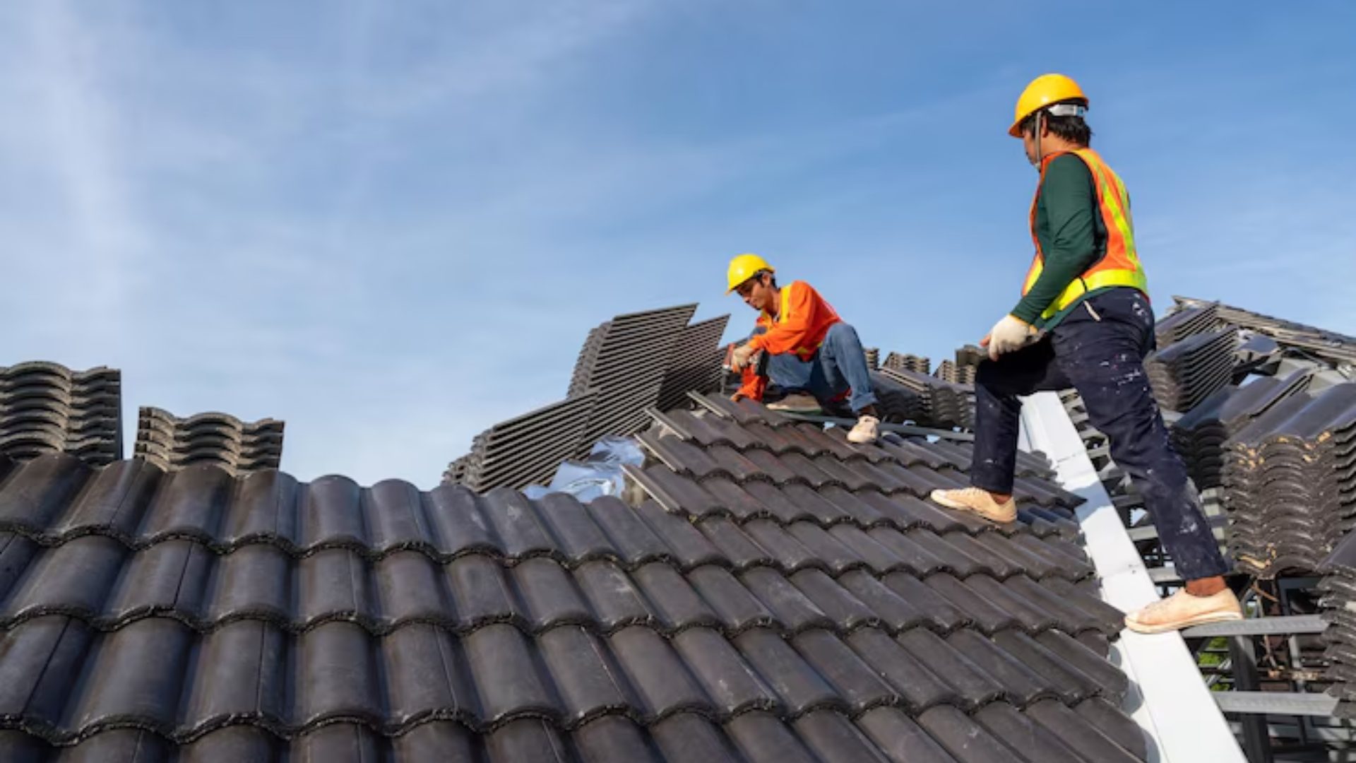 Roofer repairing missing shingles on a residential roof