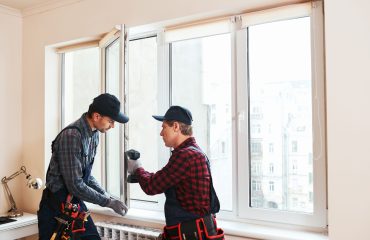 Person measuring window frame for installation