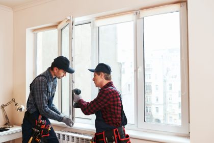 Person measuring window frame for installation