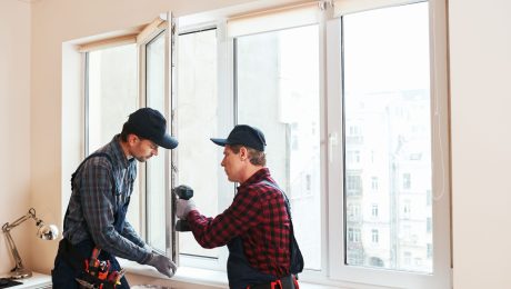 Person measuring window frame for installation